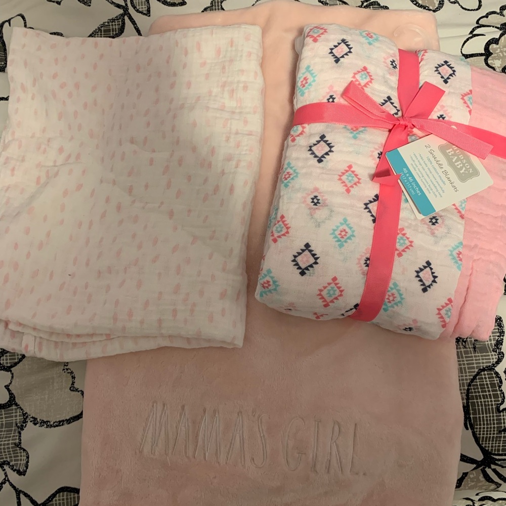 Bundle of baby girl blankets and swaddles